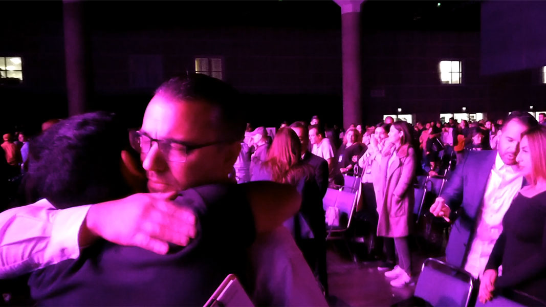 Father son hug at real estate Wealth Expo